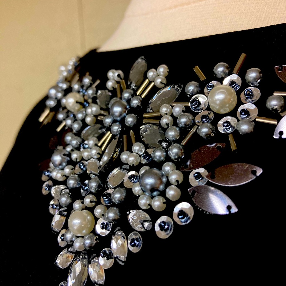 Beautifully decorated black top.